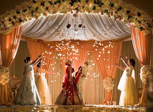 A joyful wedding celebration beneath a floral canopy